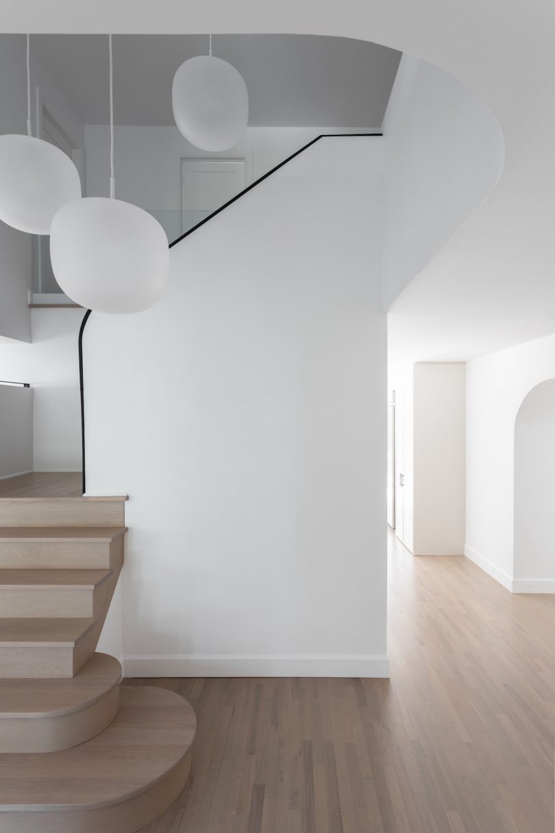 A escada define o tema de toda a casa, marcada por transições e conectividade derivadas de uma continuidade de muitos desses mesmos elementos de design.