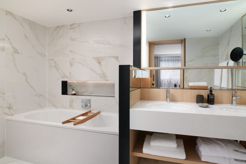 Double vanity bathroom with bathtub