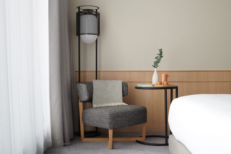 Lounge chair beside the bed in guest room