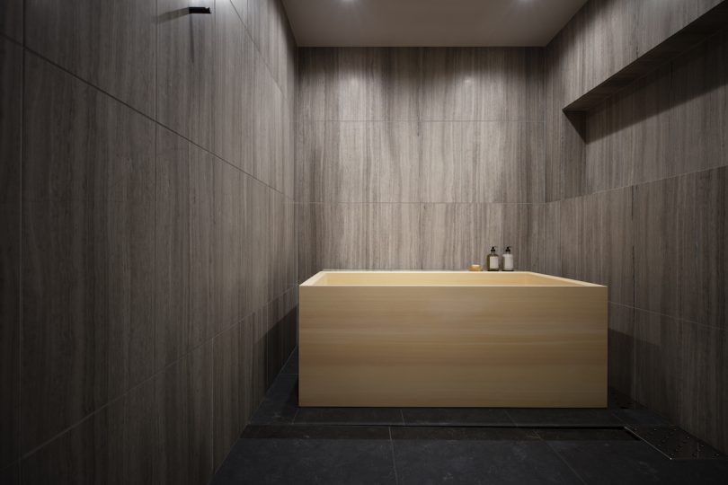 One bathroom features a Hinoki wood bathtub that serves as the centerpiece of the space