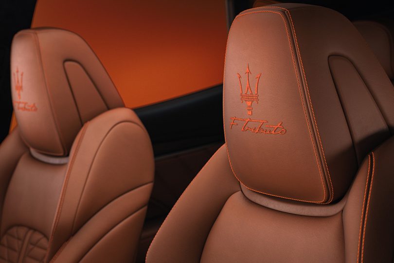 Interior detail shot of Trident logo stitching on driver side seat headrest.