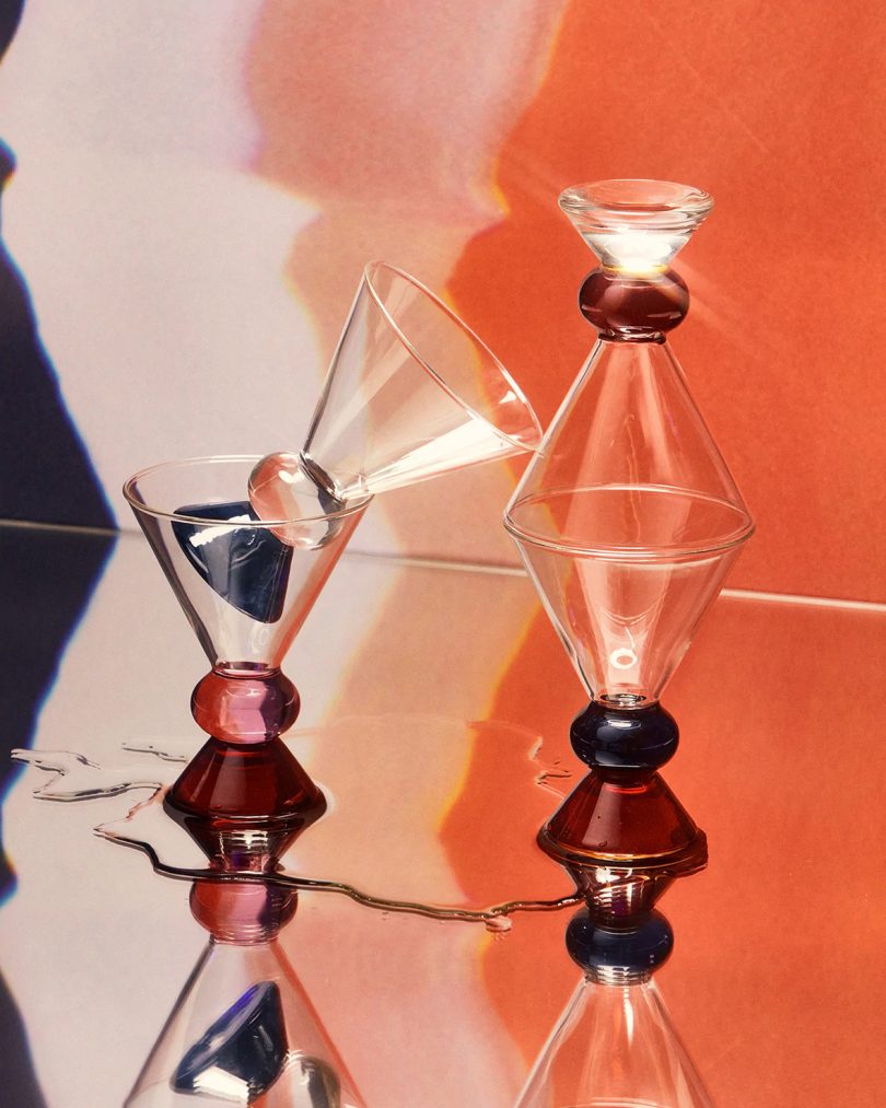 short martini-shaped glasses with pink, dark red, and blue accents