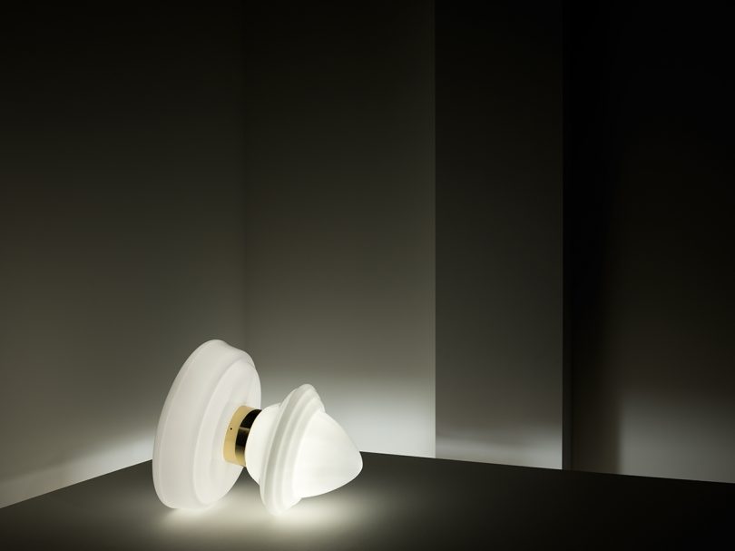 illuminated sculptural floor lamp resembling a top toy