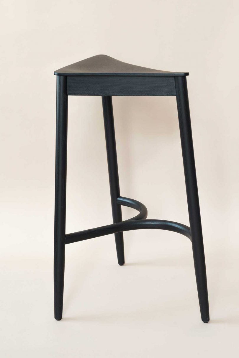 tall black triangular stool