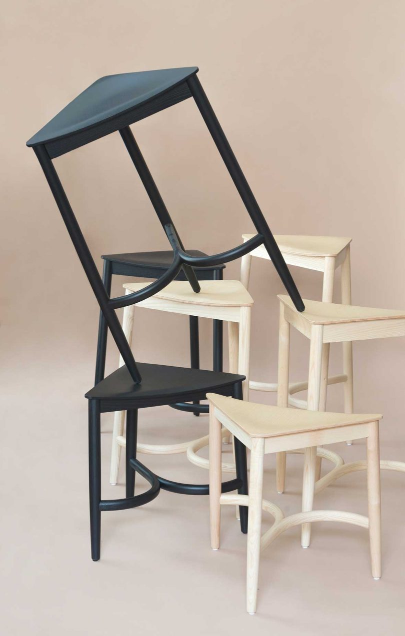 stacked natural wood and black stools