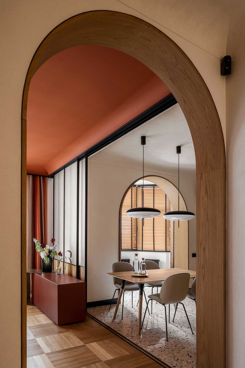 view of modern apartment interior of kitchen with light wood cabinets and terrazzo floors