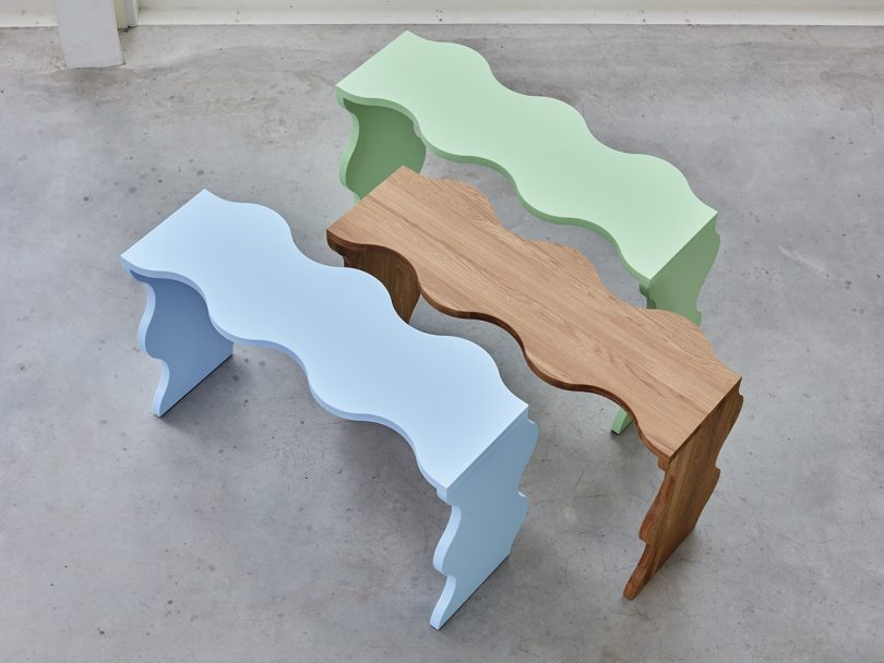 wavy light green, light blue, and natural wood library tables