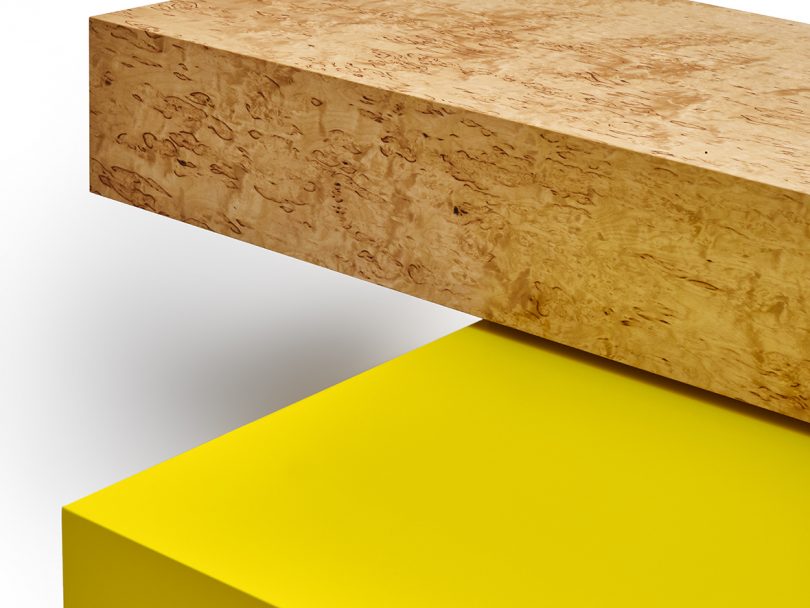 detail of natural wood and yellow overlaid plinth table