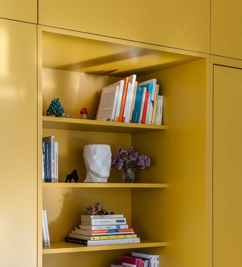 closeup shot of built-in yellow bookshelves