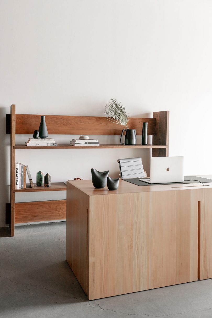 styled minimal light wood desk and medium wood shelving