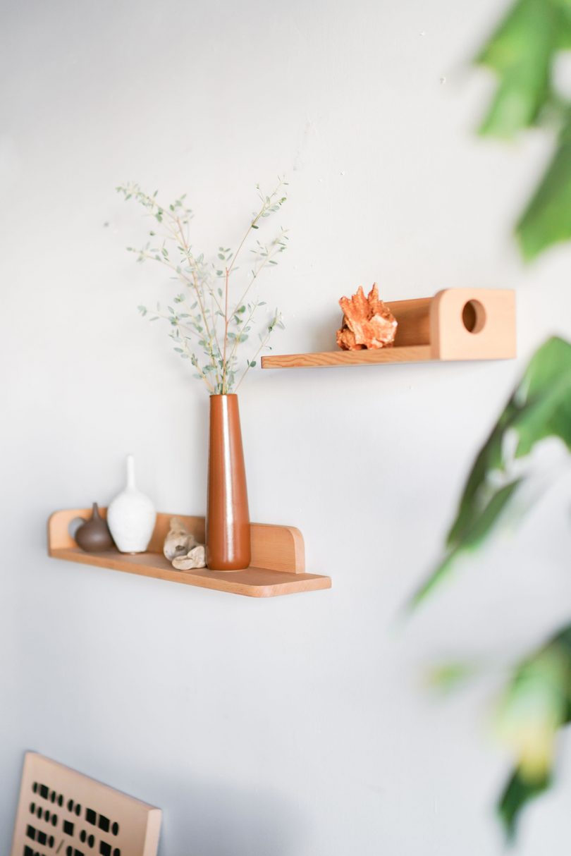 two styled light wood wall shelves