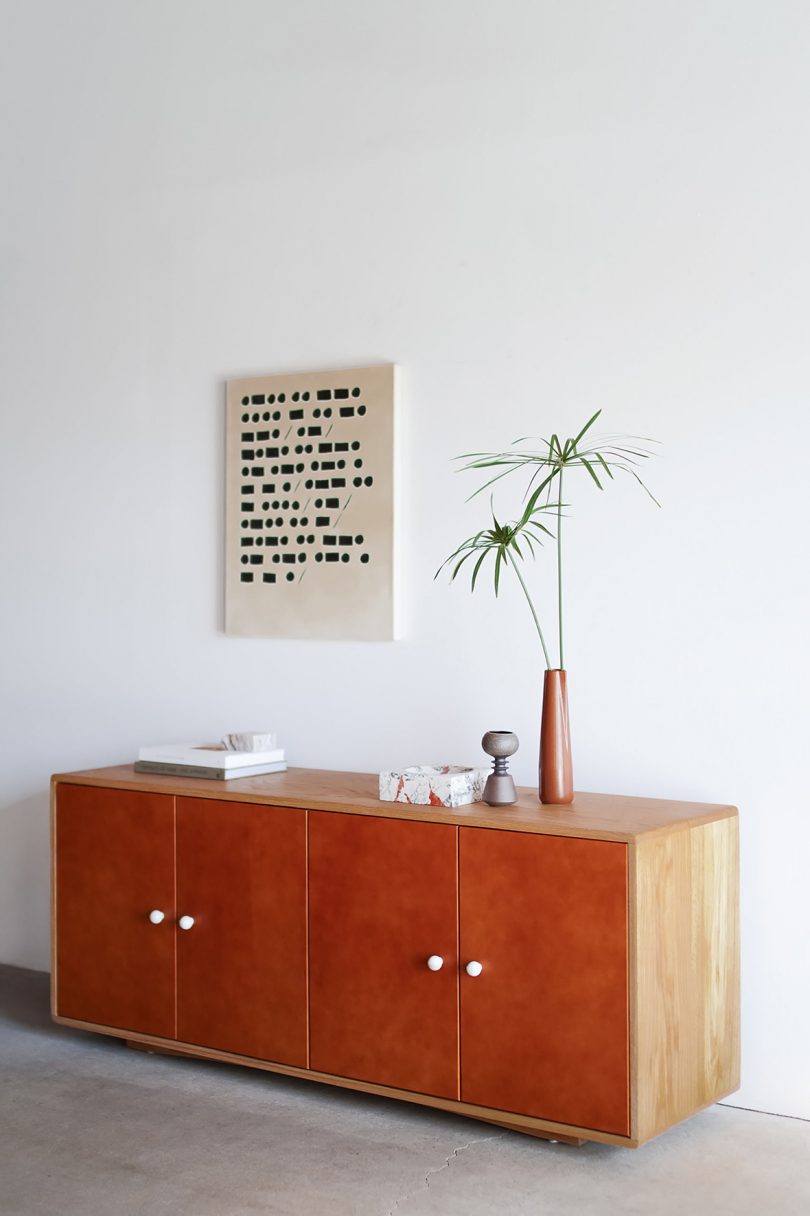 styled light wood and leather credenza
