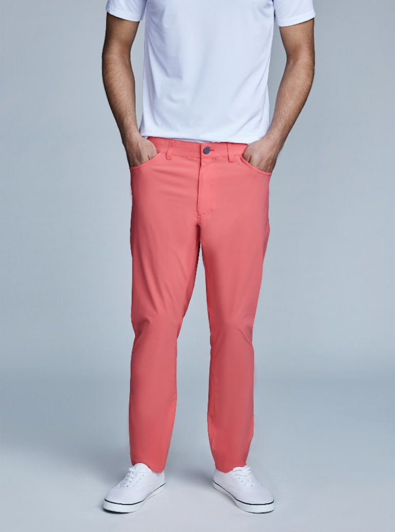 person wearing salmon colored pants and a white t-shirt