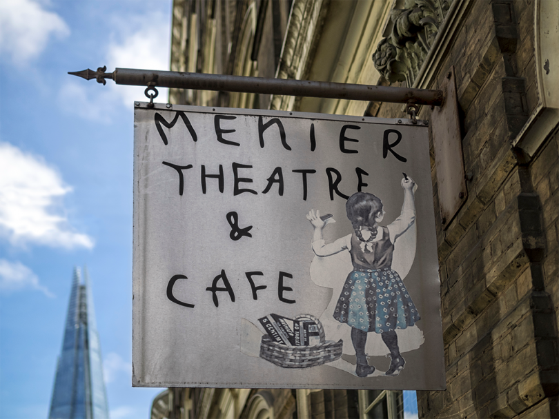 outdoor flag reading Memier Theatre & Cafe