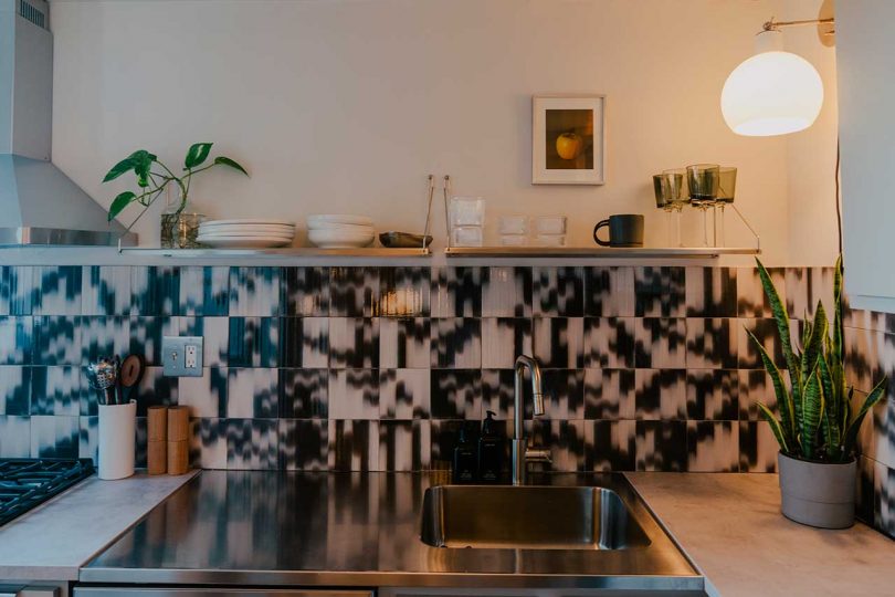 modern kitchen with black and white patterned tile backsplash