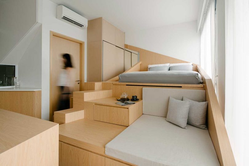 small apartment interior with a multifunctional structure housing bed and storage