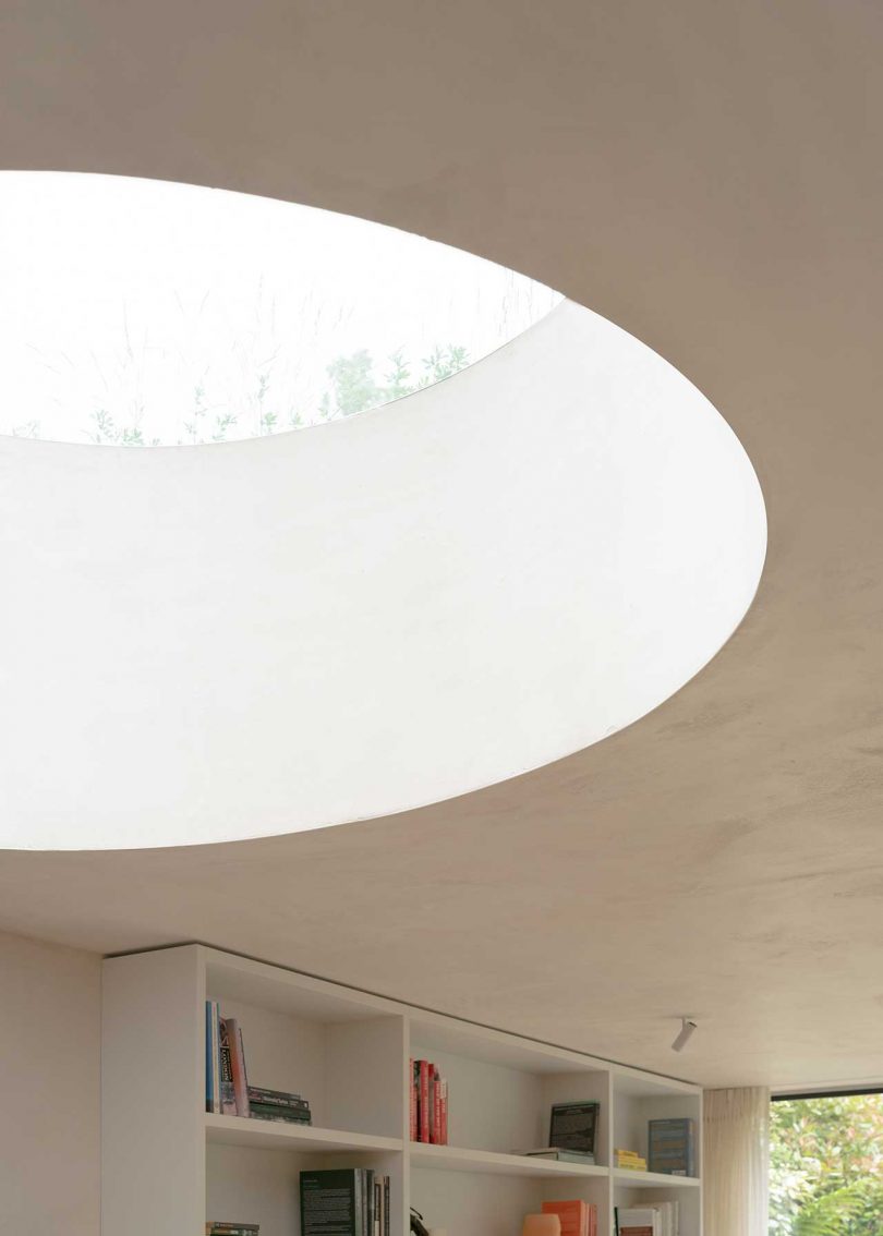 light interior of townhouse extension looking up to round skylight