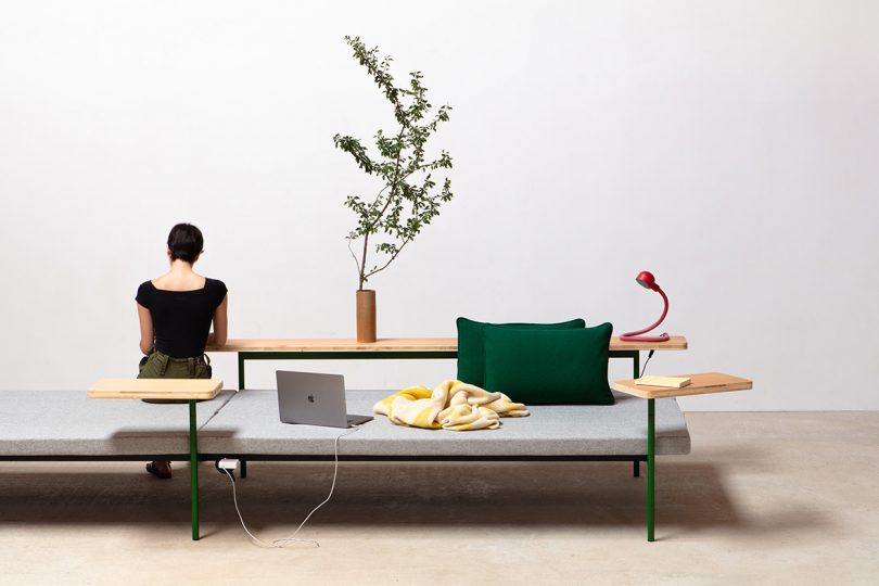 styled interior space with sofa, end table, and a light-skinned woman