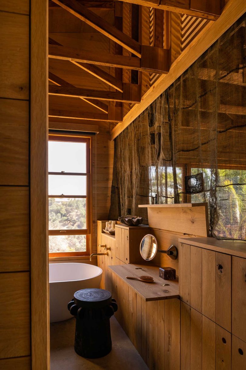 primary bathroom of modern mountain house with wood details