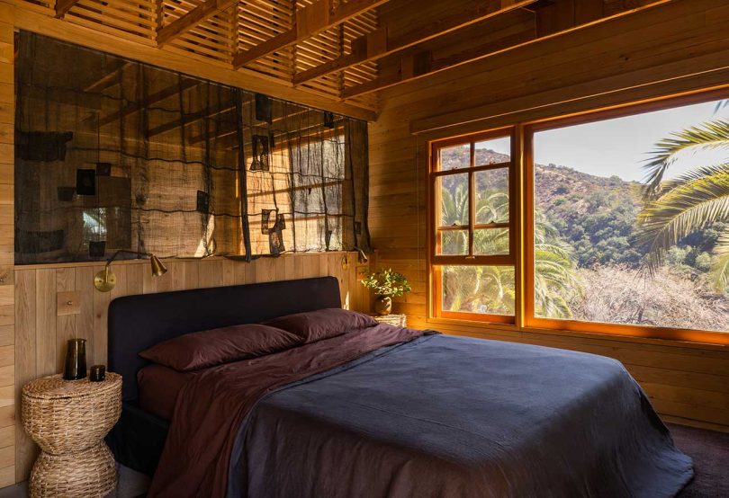 primary bedroom with wooden details overlooking mountains