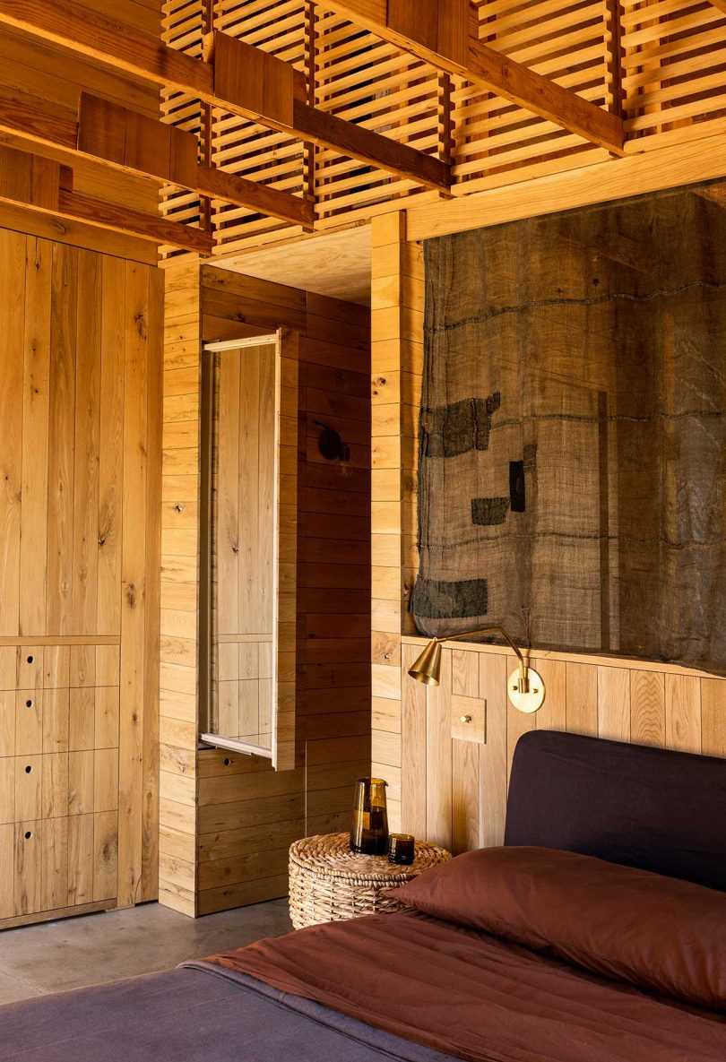 corner of primary bedroom in modern mountain house with wooden details