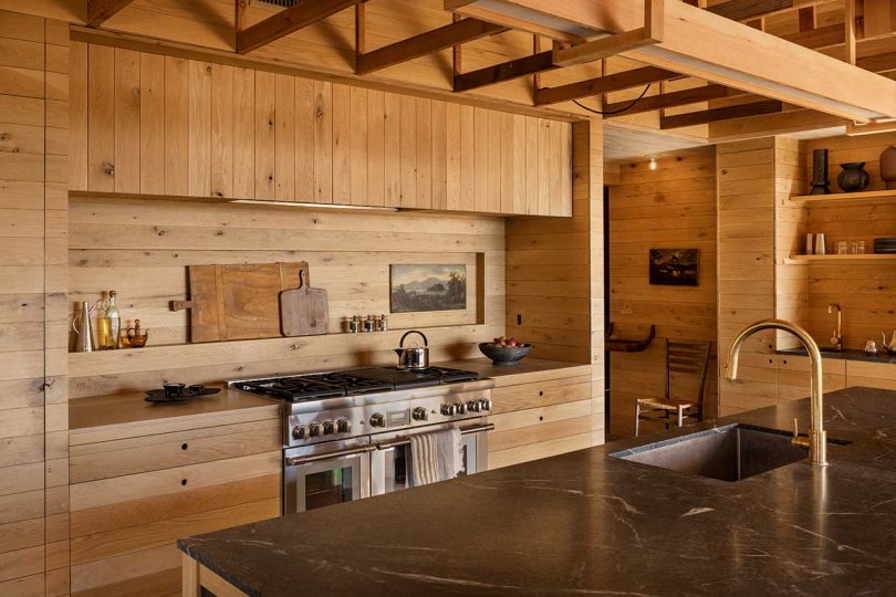 angle view of modern mountain kitchen with wood paneling