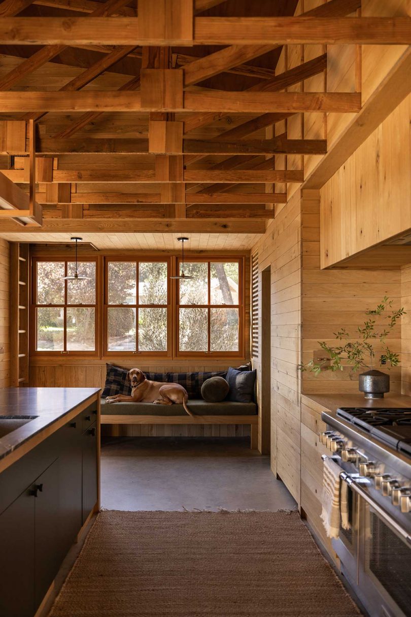 looking through modern mountain kitchen to built-in seating bench