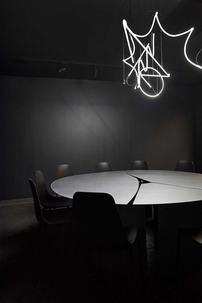 office interior conference room in all black with round table and chairs