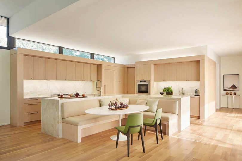 view of eat-in kitchen in neutral light colors with table and banquet seating
