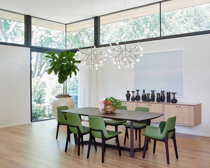 angled interior shot of open dining room with green chairs
