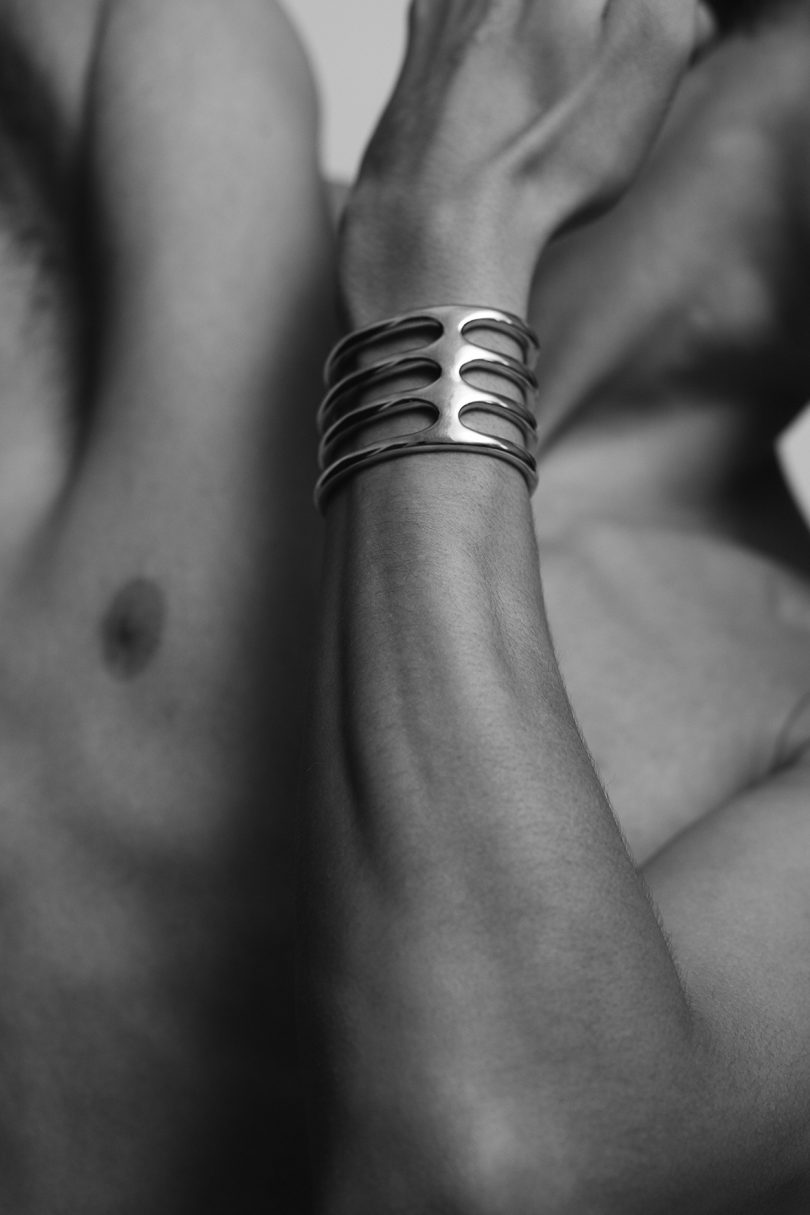 artistic black and white image of a human wearing a cuff bracelet