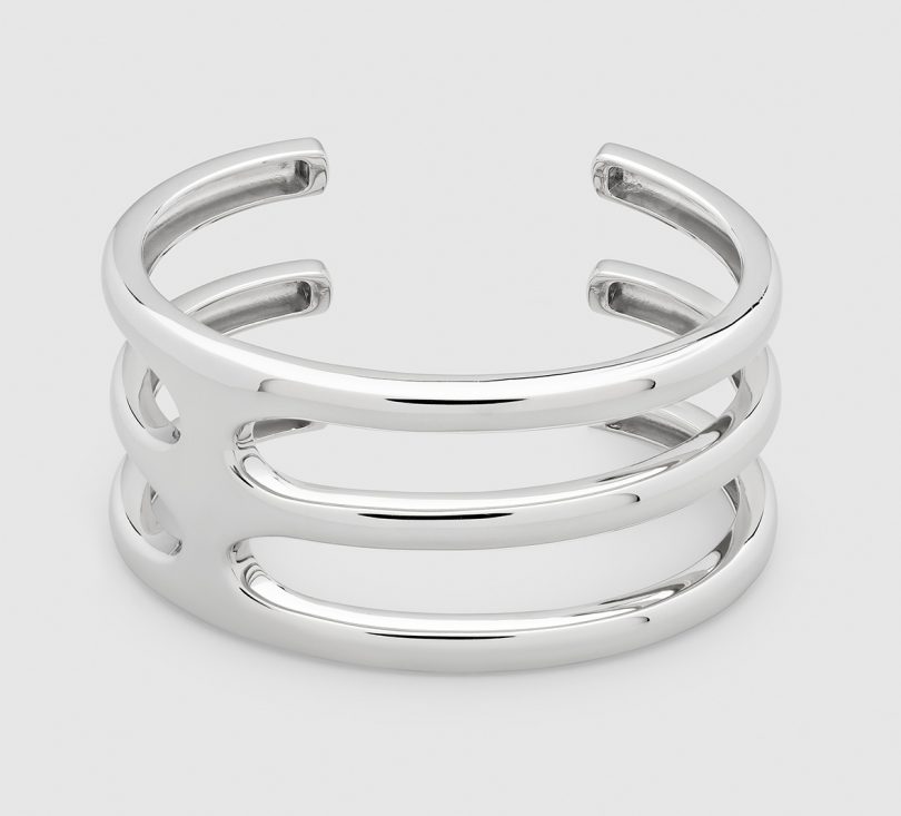 silver cuff bracelet on light gray background
