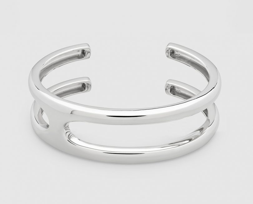 silver cuff bracelet on light grey background