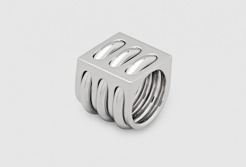 stacked silver rings on light grey background
