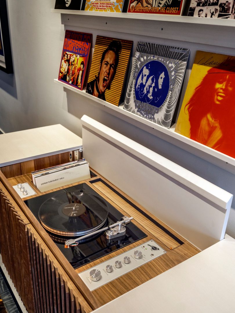 closeup of stereo console and wall shelves of records