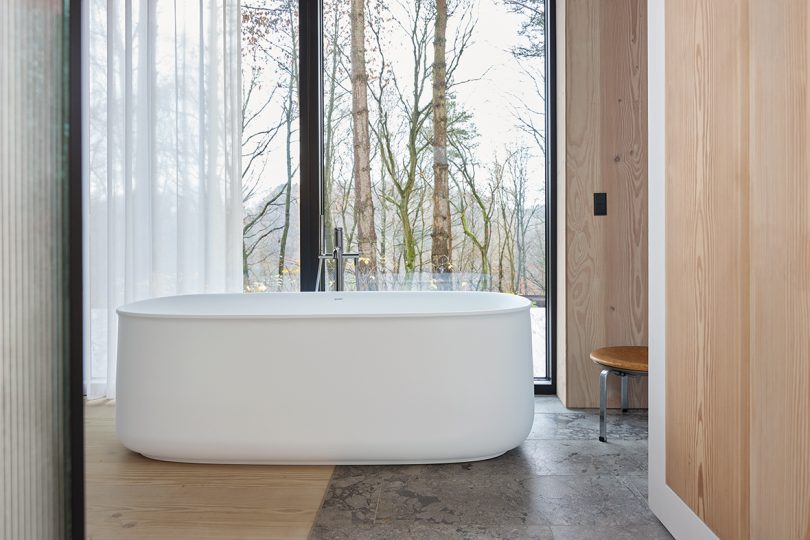 rounded white bathtub in a minimally styled space