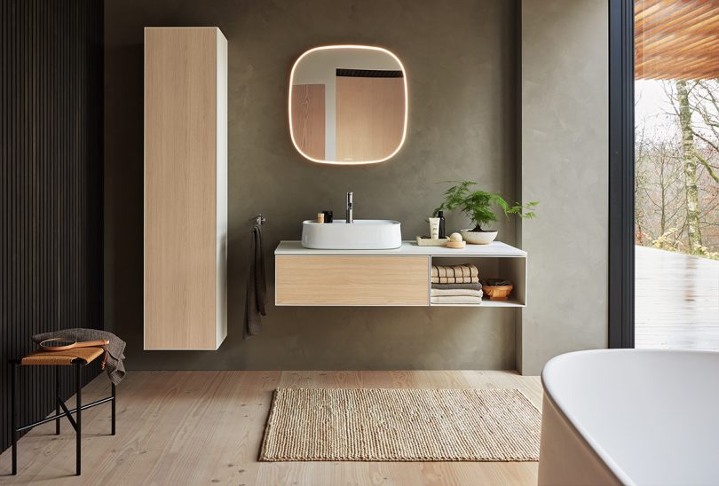 modern minimal bathroom with light wood tones and white fixtures
