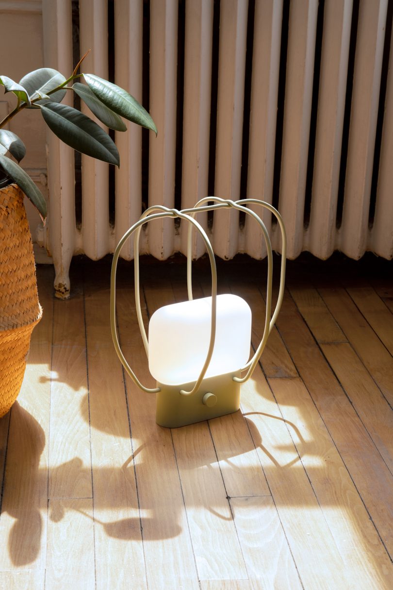 green portable caged lamp
