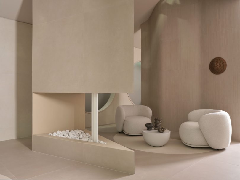 Italgraniti booth with a living room scene featuring two curved lounge chairs at Cersaie