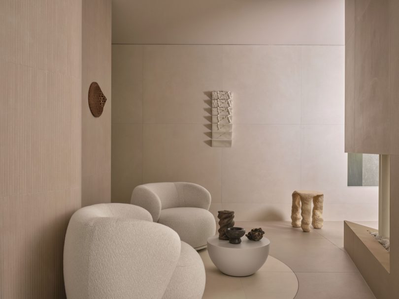 Italgraniti booth with a living room scene featuring two curved lounge chairsat Cersaie