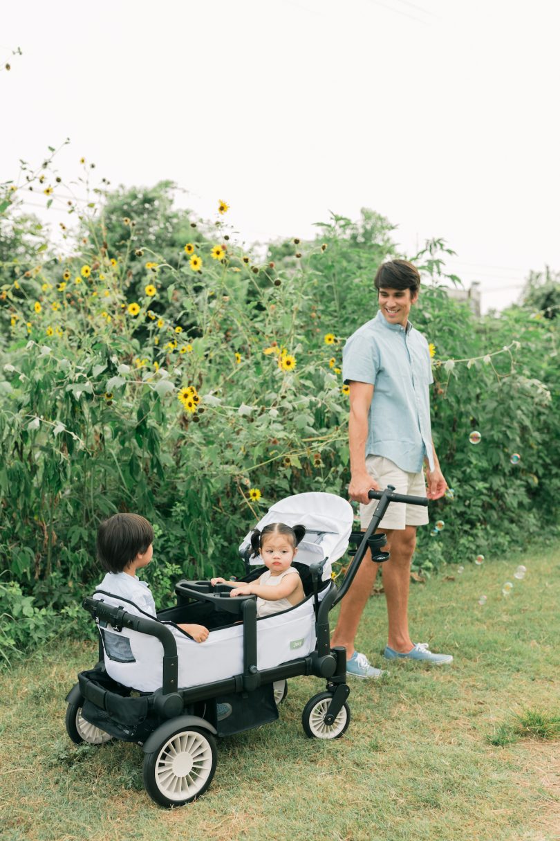 two kids in wagon with dad