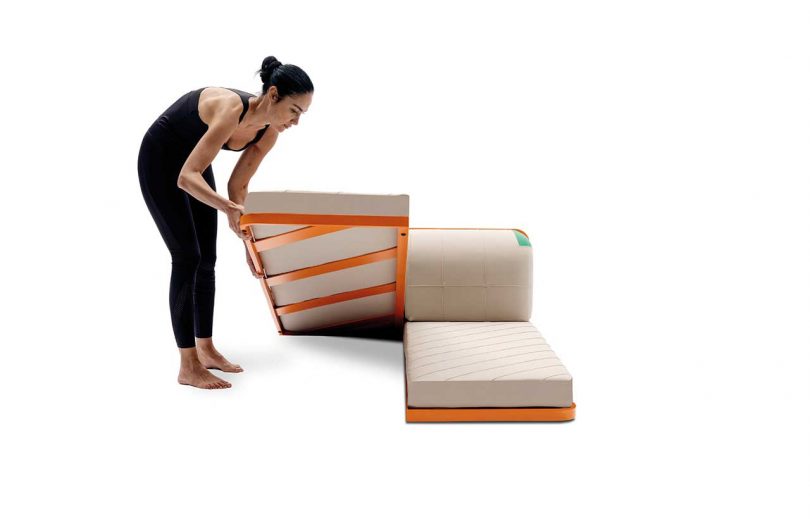 woman setting down two twin beds