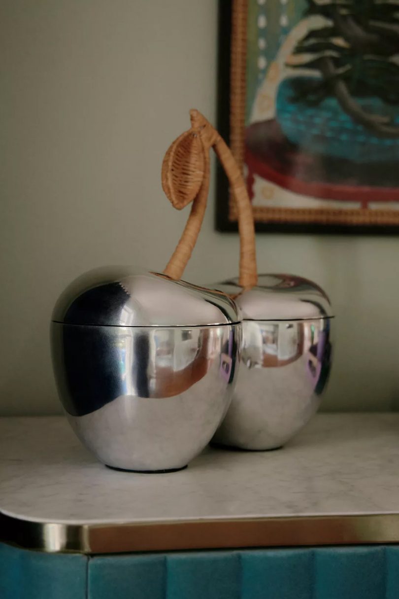 silver double-sided ice bucket shaped like two cherries with a wicker stem and leaf