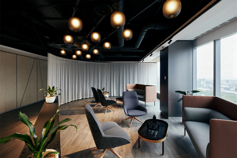 high design meeting space in grey and black hues with lots of seating