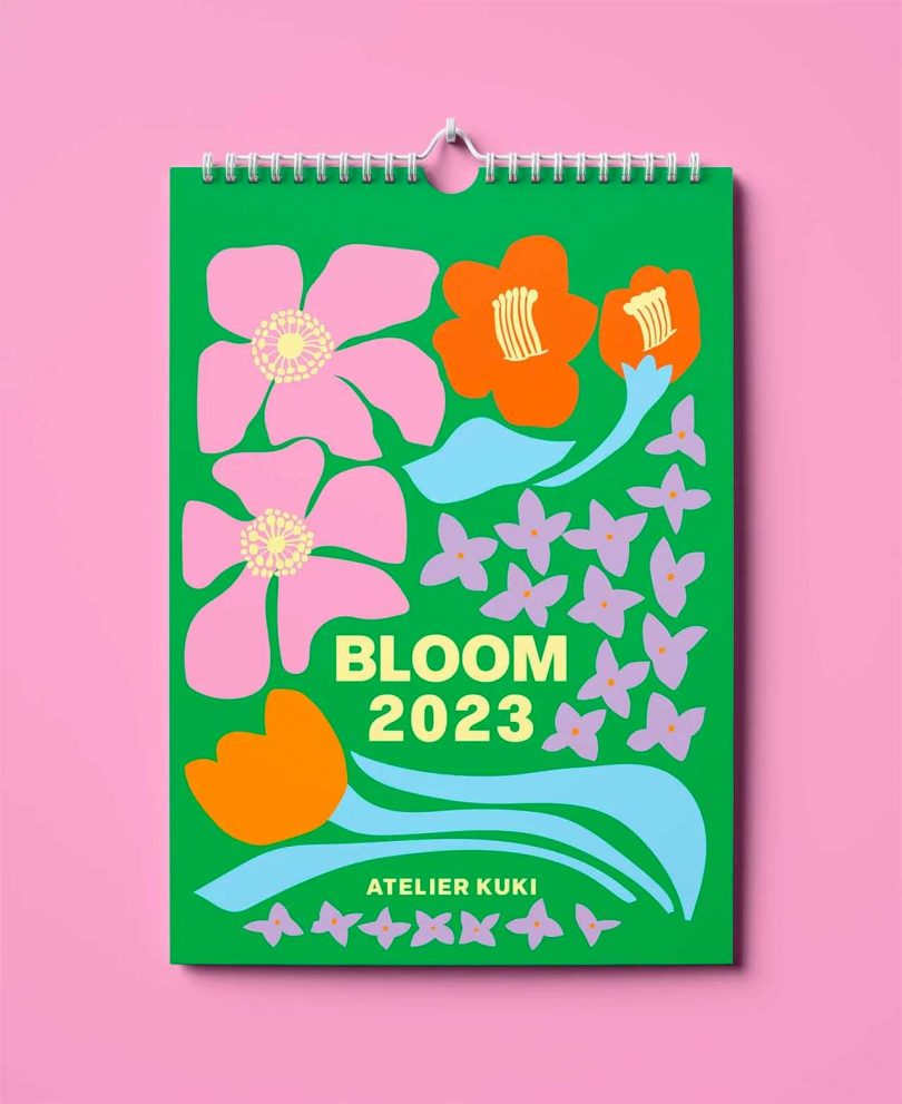 colorful green and pink bloom wall calendar on pink background