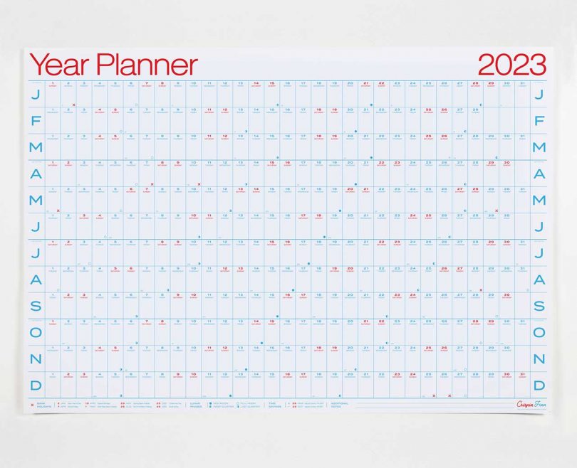 white poster-like wall calendar planner with red and blue ink