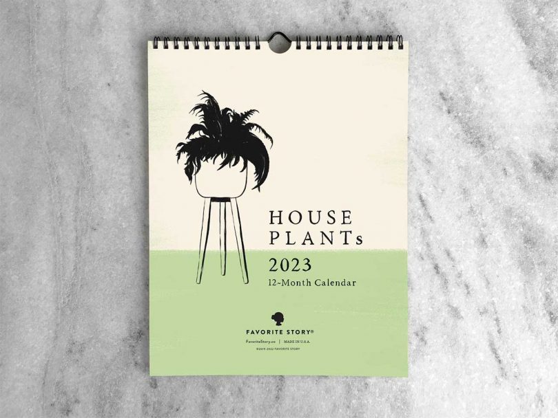 a 2023 calendar of houseplants lying on marble