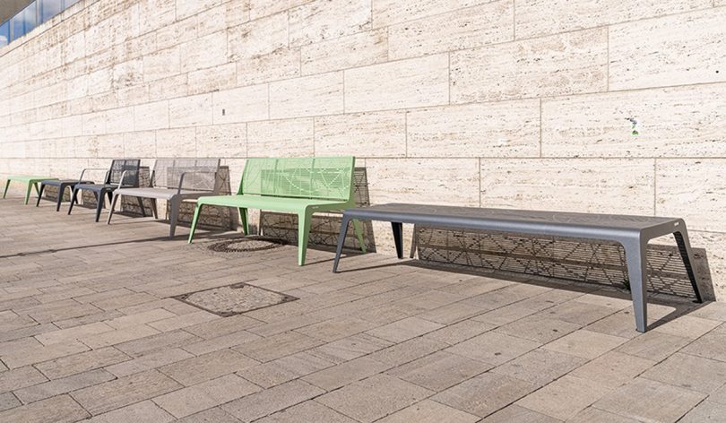 three outdoor benches lined up again the exterior wall of a building