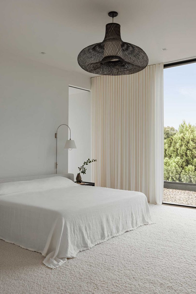 minimalist beige bedroom with large windows