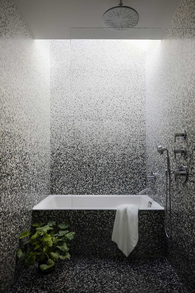 modern bathroom with tiles in a gradient that goes from black to white